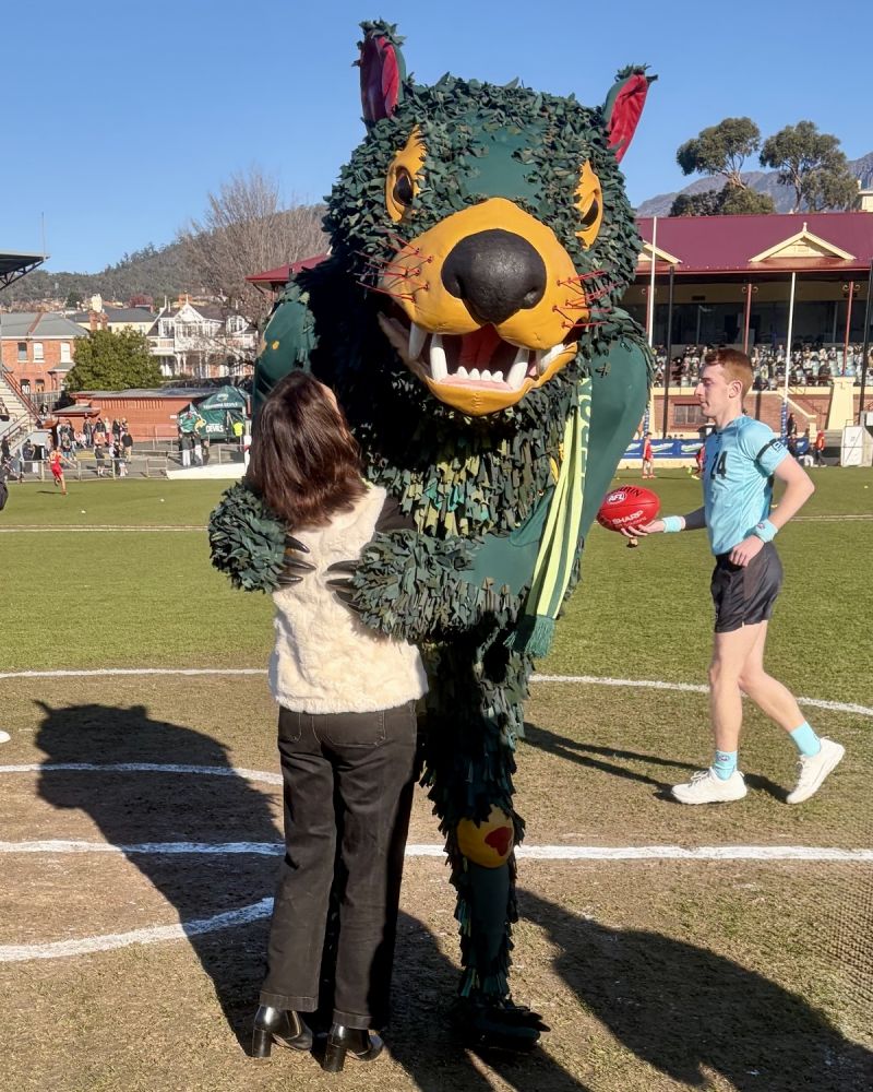 The Governor hugs Tasmania Devils mascot Rum'un at North Hobart Oval