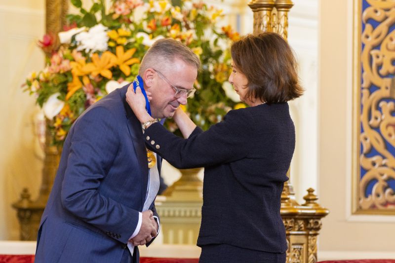 The Governor presents a medal to a man