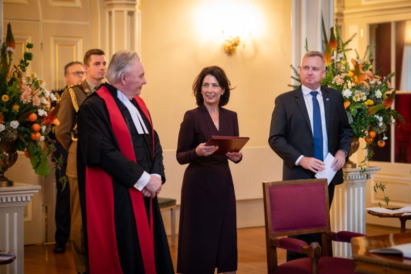 The Governor stands in the ballroom holding her Commission of Office