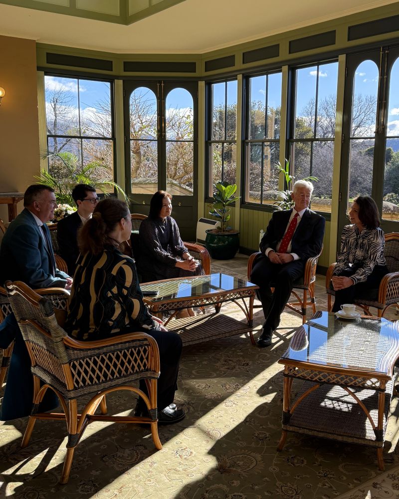 The Governor and Dr Walters sit in the Conservatory talking with two men and two women