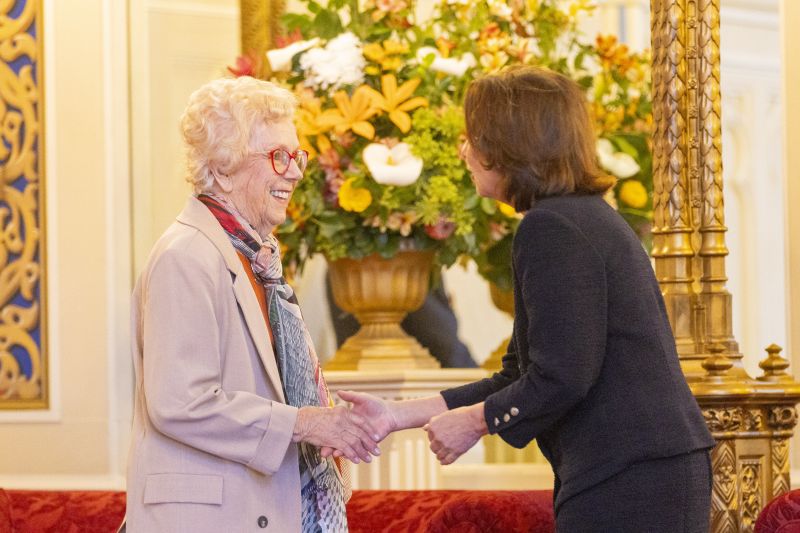 The Governor stands next to a woman