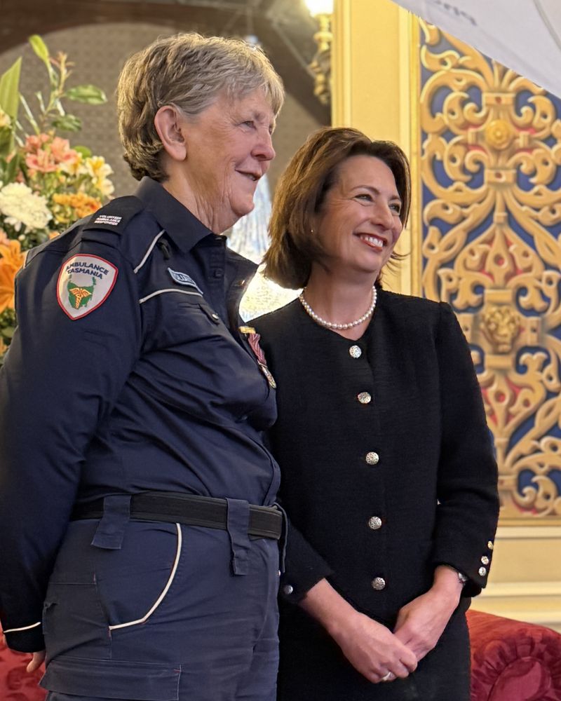 The Governor stands next to a woman