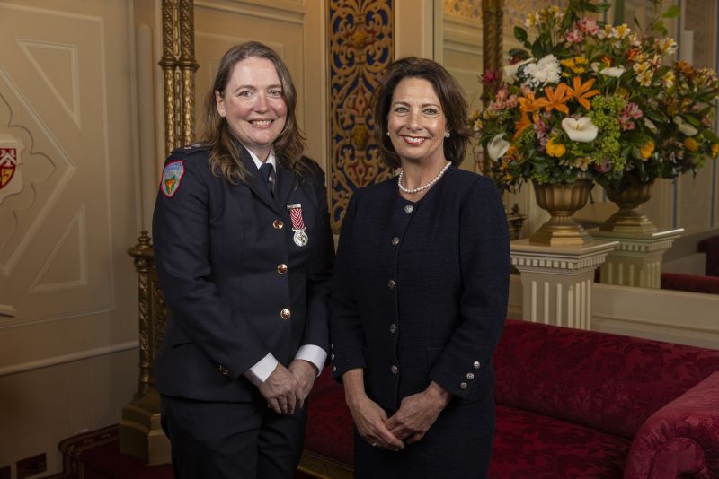 The Governor stands next to a woman
