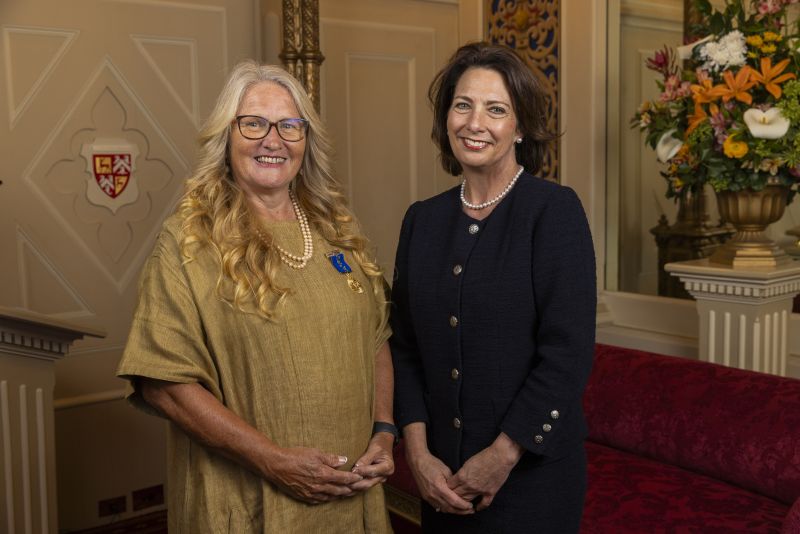 The Governor stands next to a woman