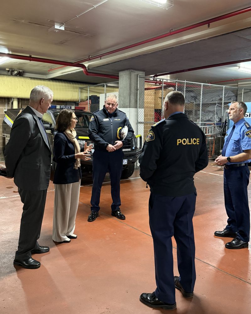 The Governor and Dr Walters stand in an underground car park talking with three Tasmania Police officers