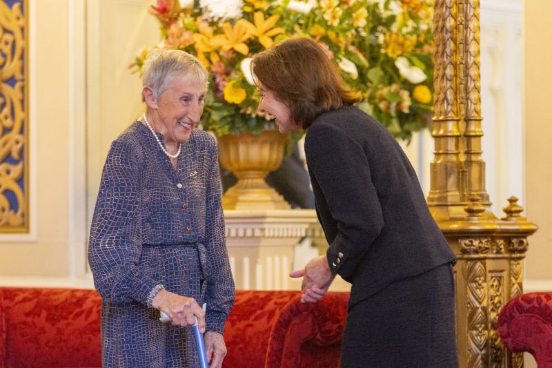 The Governor sits next to a woman