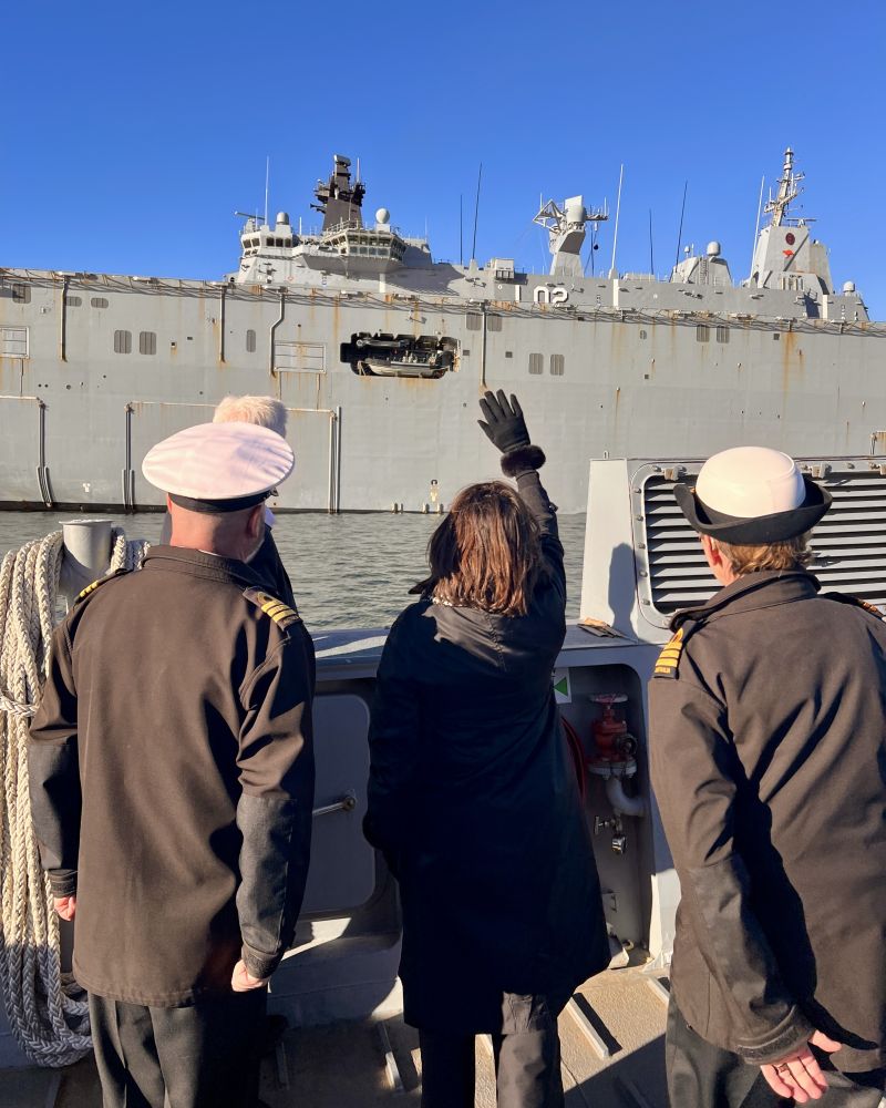 The Governor waves at HMAS Canberra from the landing craft