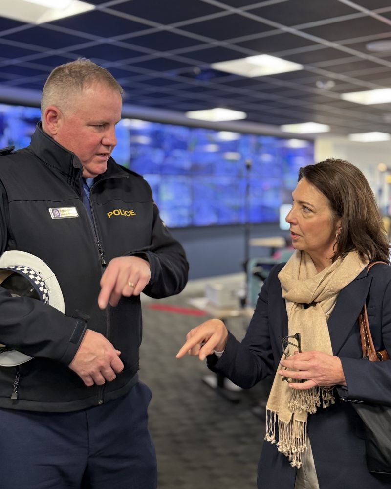 The Governor stands in an operations room, talking with a Tasmania Police officer