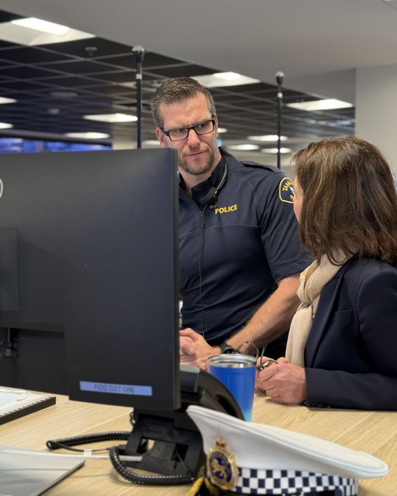 The Governor stands at a computer screen, talking with a Tasmania Police officer