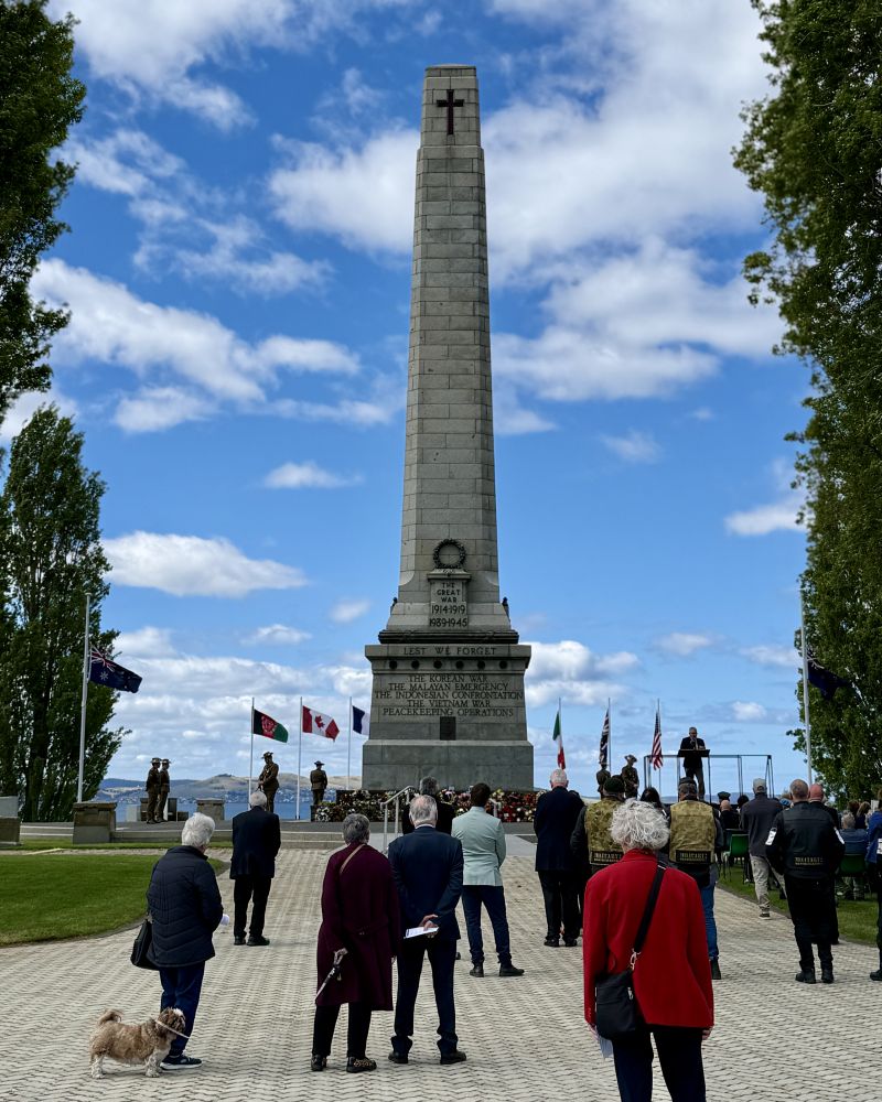People gather at the Hobart Cenotaph as a service takes place