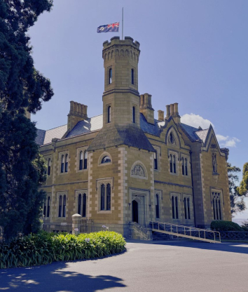 Government House with the flag flying half mast