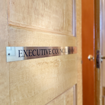 A door with a brass plaque reading 'Executive Council Room'