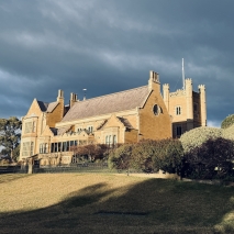 Government House with a dark grey-blue sky in the background