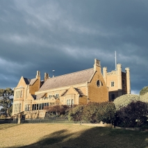 Government House with a dark grey-blue sky in the background