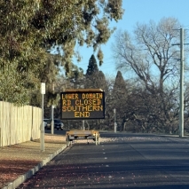 An image of Lower Domain Road with a sign listing an upcoming road closure
