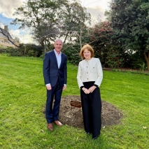 Her Excellency and Peter Gutwein standing next to a new oak tree on the Government House lawn