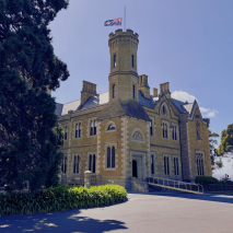 Government House with the flag flying half mast