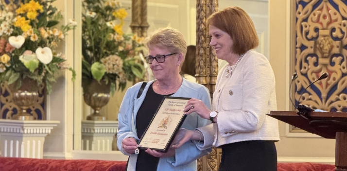 Her Excellency presents a life membership to Debbie Emmerton