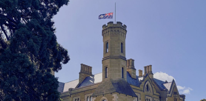 Government House with the flag flying half mast