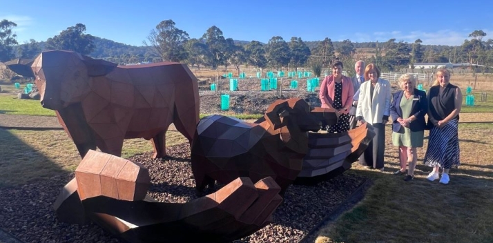 Her Excellency, Professor Chalmers, Mayor Triffitt and staff with a large metal sculpture outdoors at the Bothwell District High School