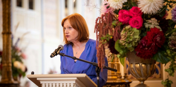 Her Excellency speaking at a lectern.