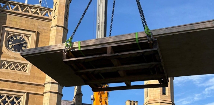 A crane lifting materials onto the roof of Government House