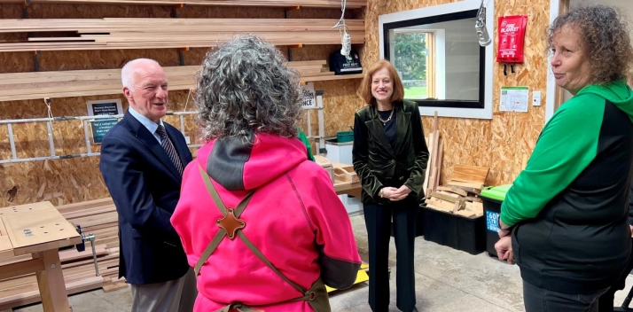 The Governor and Professor Chalmers in a woodworking workshop talking to two women