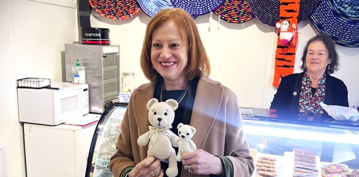 The Governor standing in a shop holding two teddy bears
