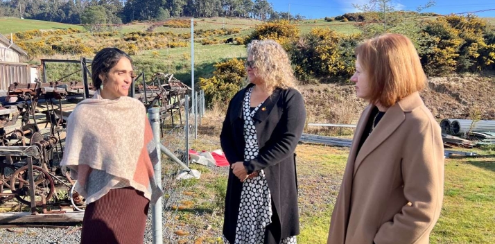 The Governor standing outdoors talking to two women
