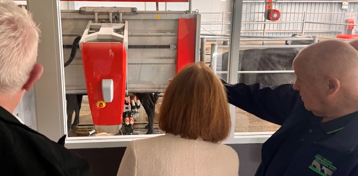 Her Excellency looking at a robotic dairy machine