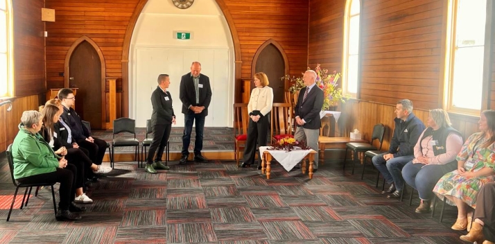 Her Excellency and Professor Chalmers inside an old church building talking to a group of people