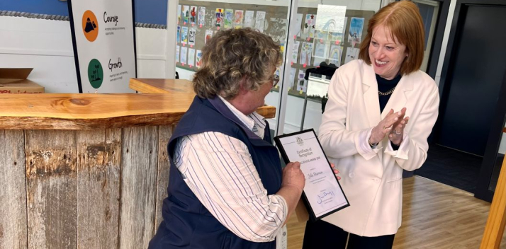 The Governor presents a certificate to teacher Julie Sharman